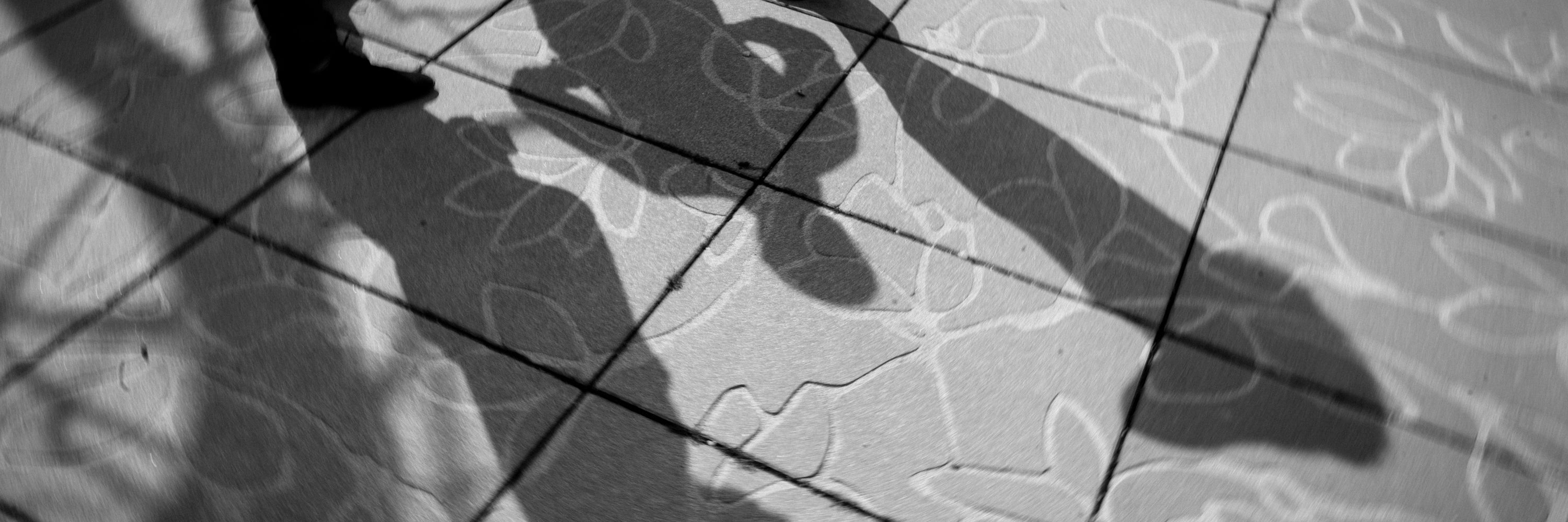 3 shadows on courtyard floor